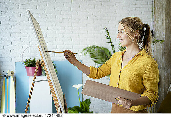 Woman painting at home