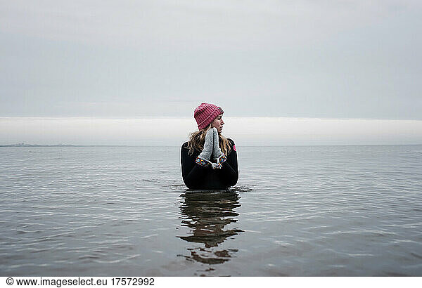 woman peacefully stood cold water swimming in winter