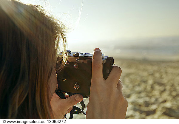 Woman photographing at beach