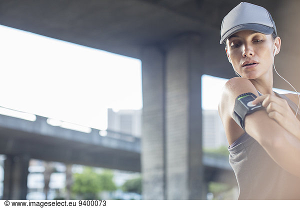 Woman playing music before exercising