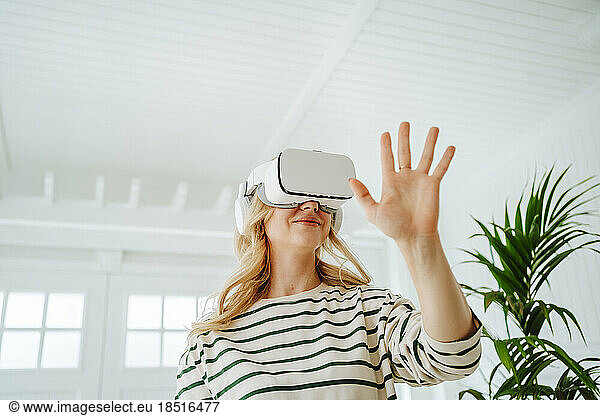 Woman playing virtual game at home