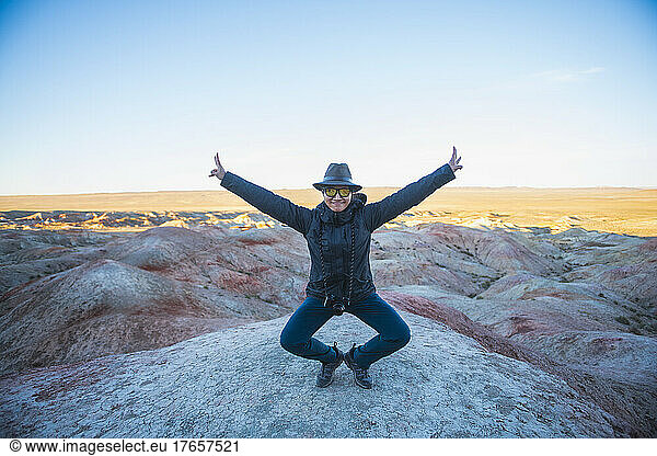woman posing for the camera at the Flaming cliffs in the Gobi desert