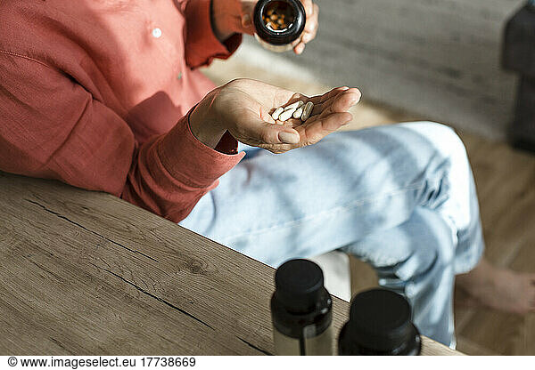 Woman pouring pills into her hand
