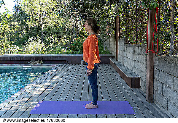 Woman practicing Yoga outdoors.