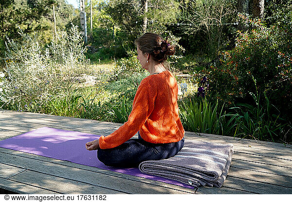 Woman practicing Yoga outdoors.