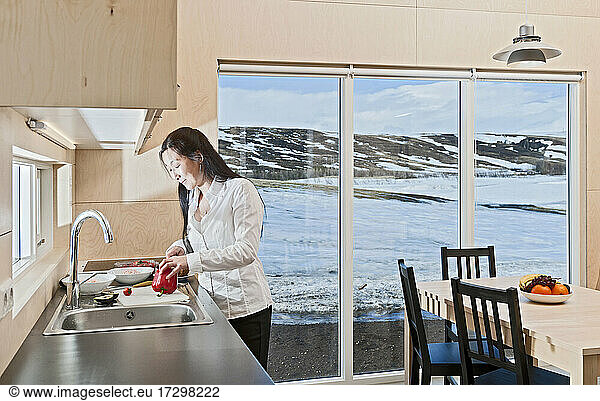 woman preparing food inside Icelandic holiday home