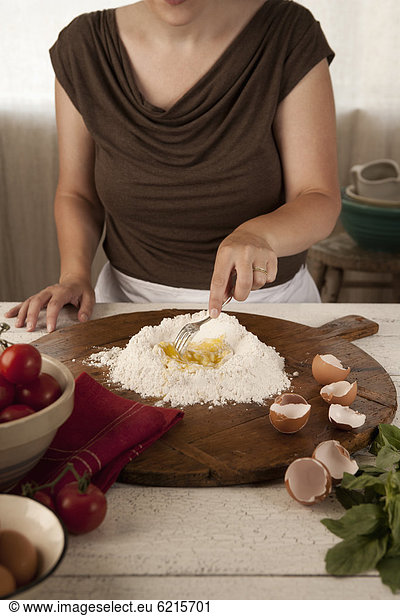 Woman preparing pasta dough