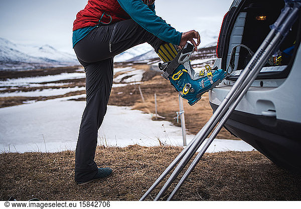 Woman putting on backcountry ski boot in Iceland