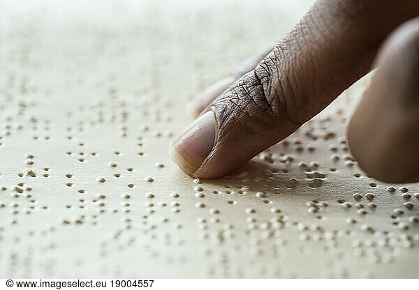 Woman reading braille text from book