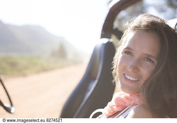 Woman relaxing in sport utility vehicle