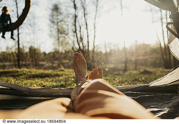 Woman relaxing in tent on sunny day