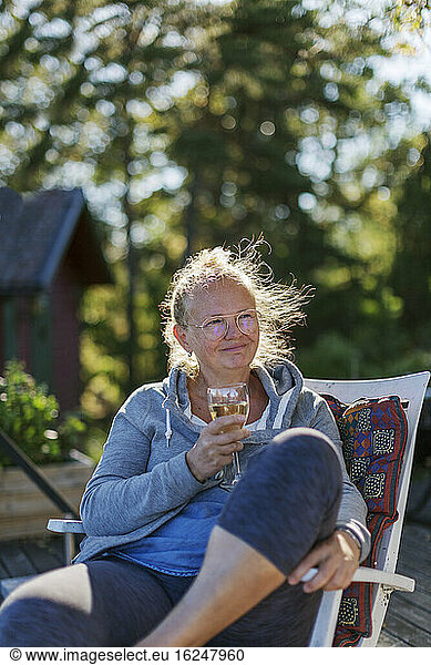 Woman relaxing with glass of wine