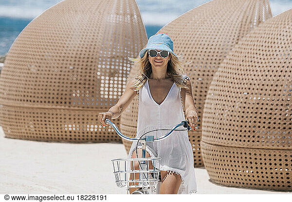 Woman riding bicycle on the beach
