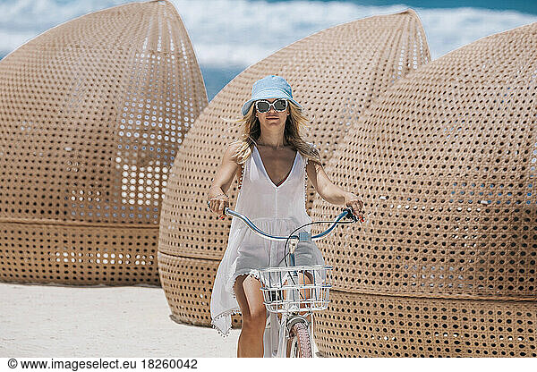 Woman riding bicycle on the beach