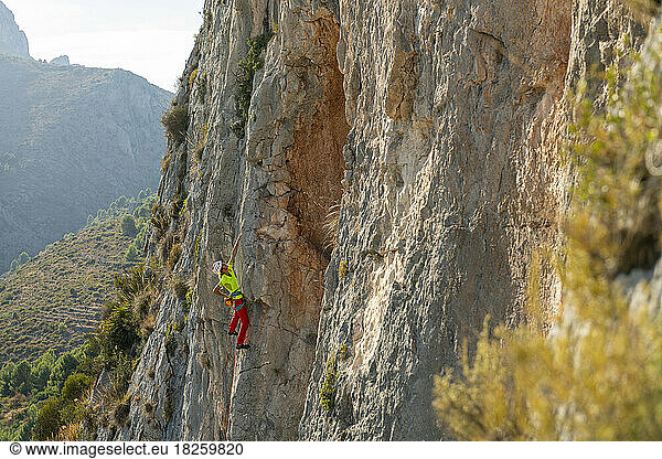 Woman rock climbing near Bolulla village  Alicante.  Spain