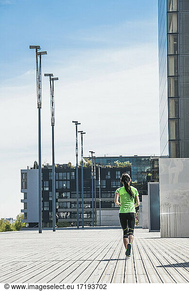 Woman running at modern building in Paris