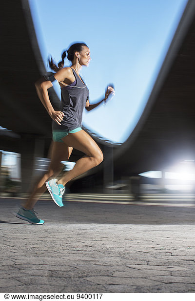 Woman running through city streets