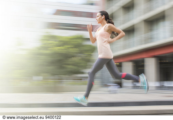 Woman running through city streets