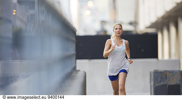 Woman running through city streets