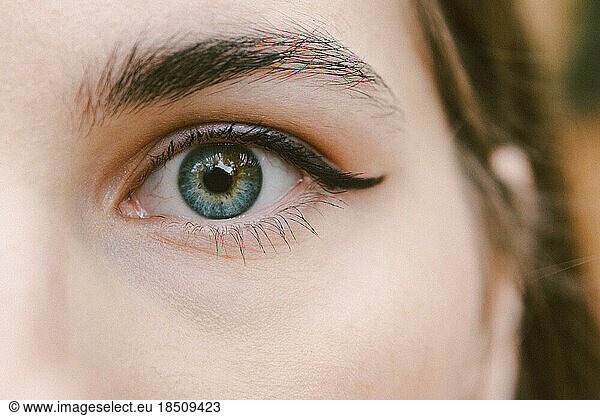 woman's eye and face are in focus in the photo