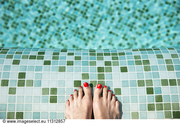 Woman's feet at poolside