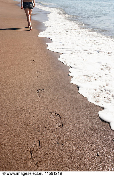 Woman?s footprints on beach
