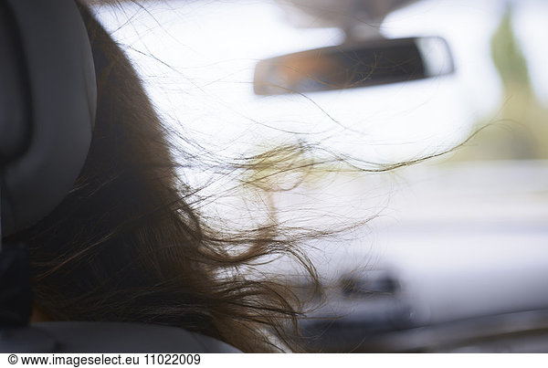 Womanís hair blowing in car