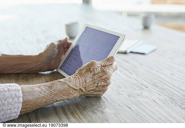 Woman's hands holding digital tablet  close-up