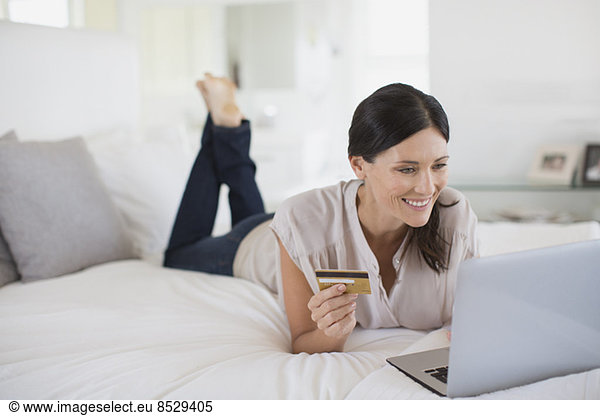 Woman shopping online with laptop