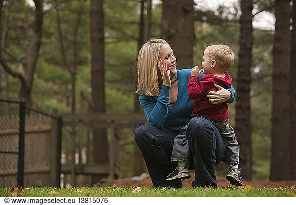 Woman signing the word ´Mommy´ in American Sign Language while communicating with her son