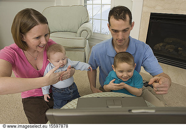 Woman signing the word 'Baby' in American sign language while sitting with her family