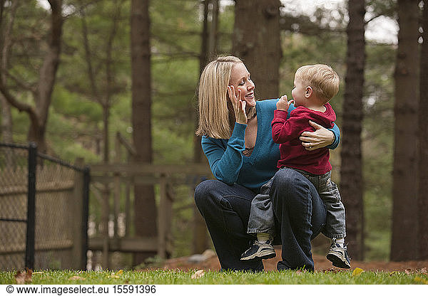 Woman signing the word 'Mommy' in American Sign Language while communicating with her son