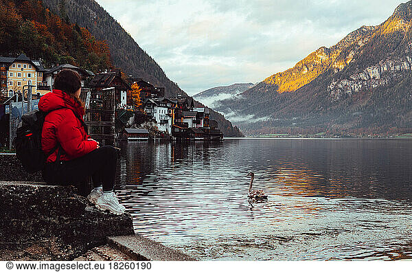 woman sitting and looking at the panorama by the lake