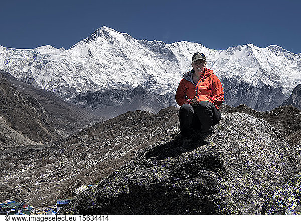 Woman sitting in the Himalayas near Gokyo lake  Solo Khumbu  Nepal