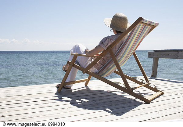 Woman Sitting on Deck Chair