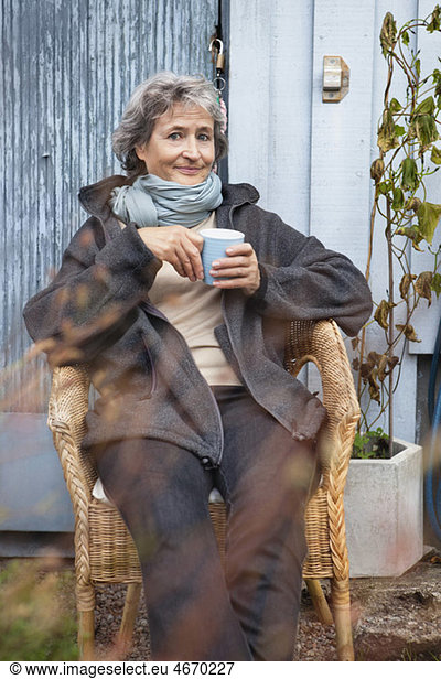 Woman sitting with coffee cup in hand