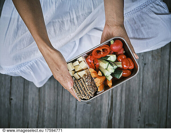 Woman sitting with lunch box
