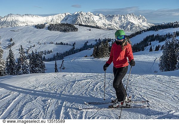 Woman skiing  view from the ski area SkiWelt Wilder Kaiser Brixenthal to the mountain massif Wilder Kaiser  Tyrol  Austria  Europe