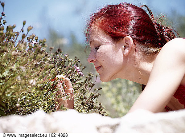 Woman smelling flowers  outdoors