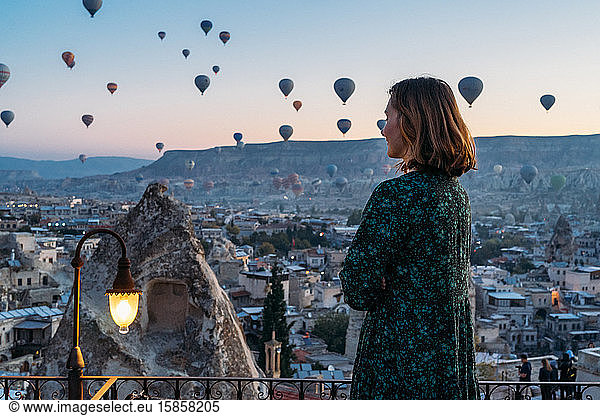 Woman soaking in a magical hot air balloon morning in Cappadocia