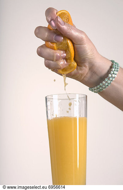Woman Squeezing Orange  Making Orange Juice
