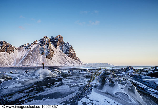 Woman standing among remote  icy landscape  Hofn  Iceland