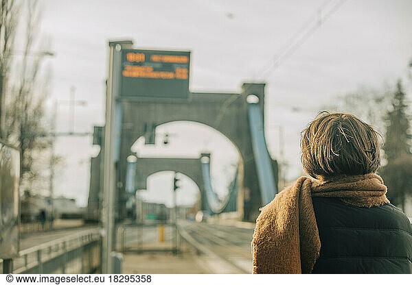 Woman standing at tram station