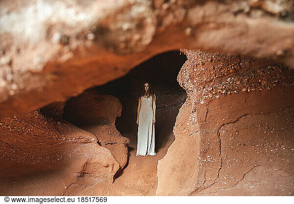 Woman standing in red cave