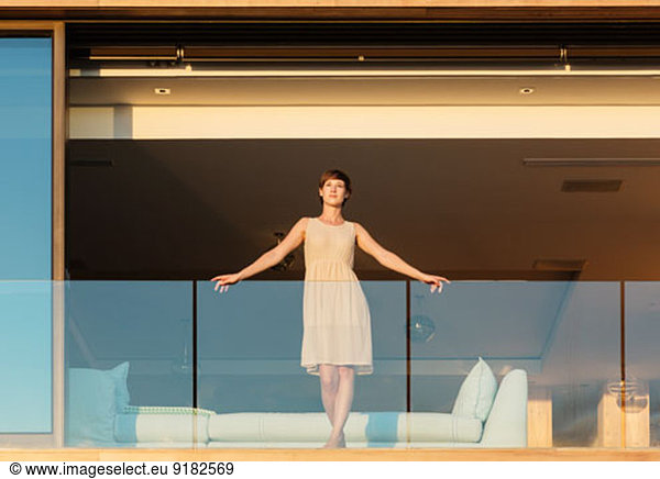 Woman standing on luxury balcony