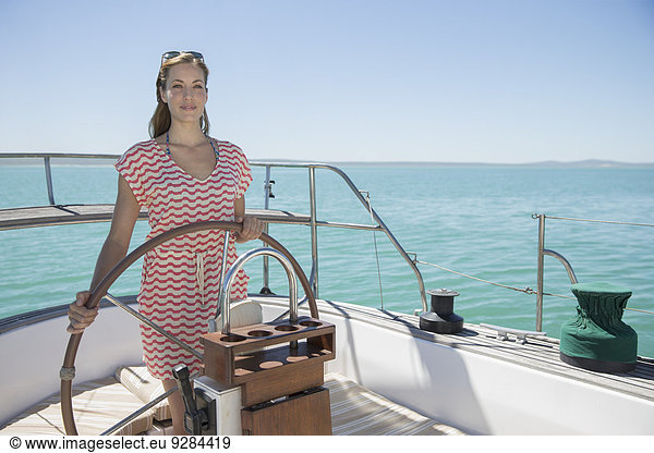 Woman steering boat on water