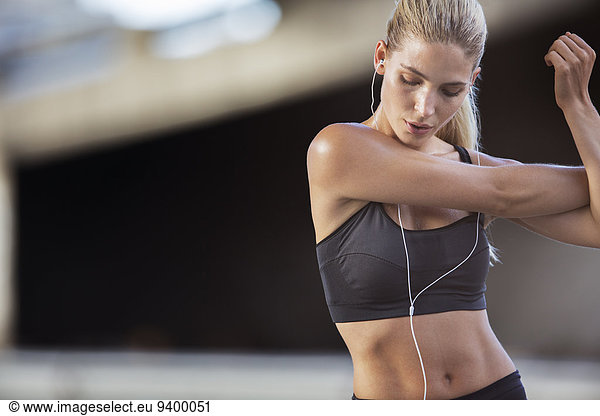 Woman stretching arms before exercise