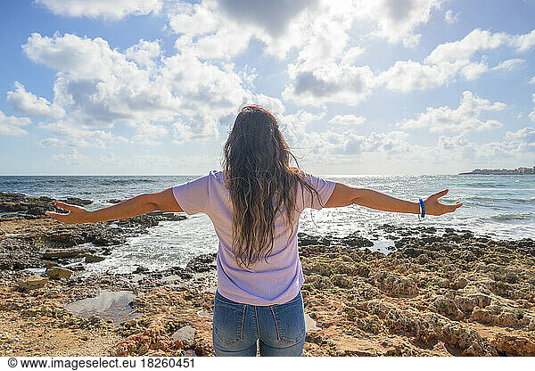 woman stretching her arms breathing fresh air on the Mediterranean