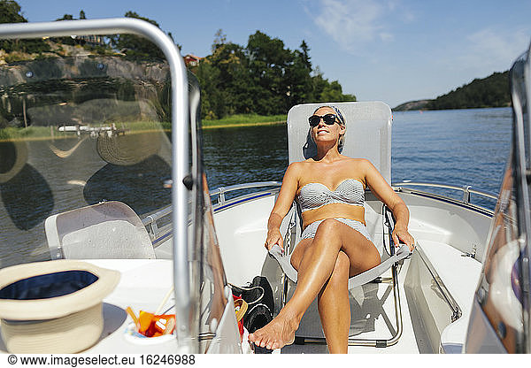Woman sunbathing on boat