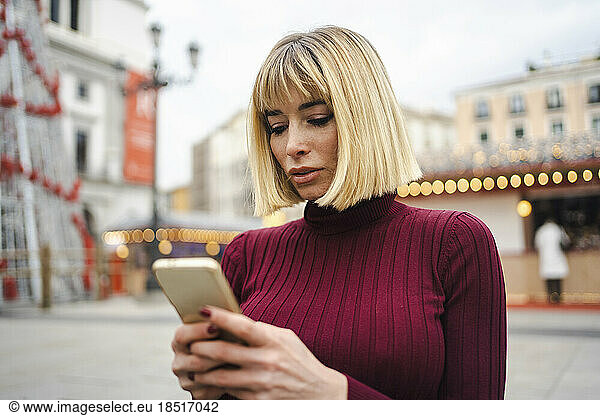 Woman surfing net through mobile phone